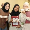 Women with certificates outdoors